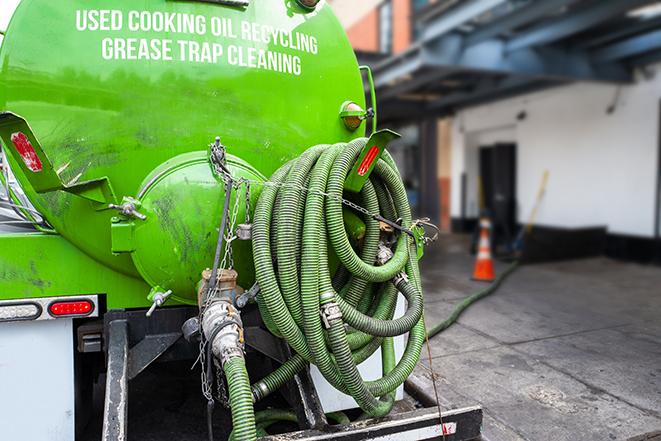 grease trap being pumped out by service technician in Green OH